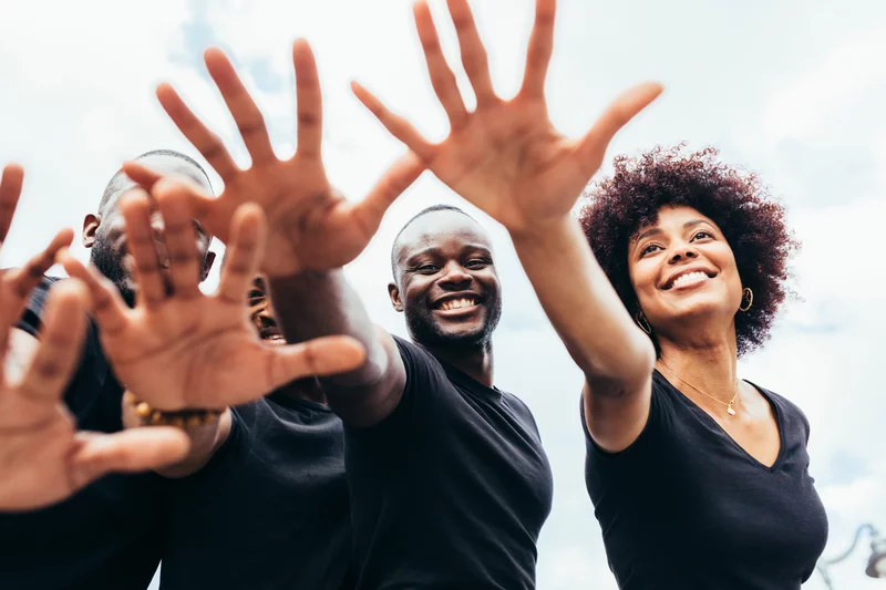 Diverse group of people in a community gathering, symbolizing unity and support.
